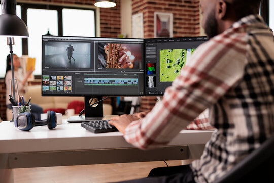 Content creator editing video montage on film production software, working on movie footage to create professional multimedia content. Using creative app with grading on computer.
