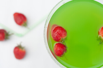 Colorful bright green cocktail cactus with strawberries, delicious refreshing