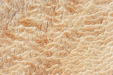 texture of white stones in pamukkale. white layers of calcium in Turkish pamukkale. white mounds of...