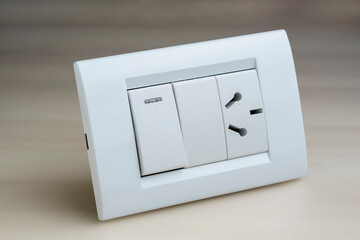 white electrical outlets and switch key on a light background.