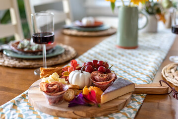 Selective focus fall charcuterie board on a dining room table