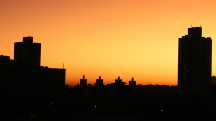 sunrise time and buildings silhouette