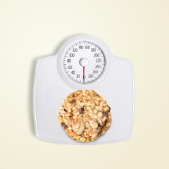 Chocolate chip cookie as an weight scale. Diet concept.