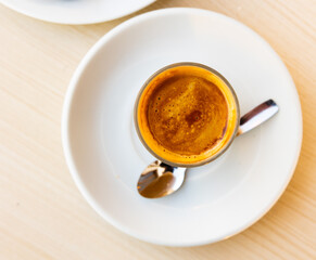Mug of cortado served on table in cafe. Traditional Spanish coffee.
