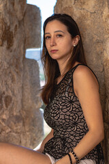 Fototapeta premium Portrait young attractive woman look at camera serious standing over isolated stone wall background