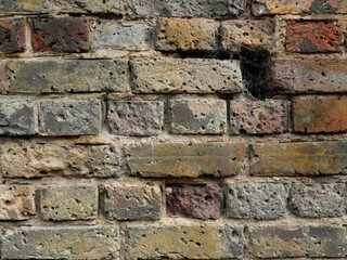 Old Brick wall weathered and damaged