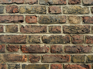 Old Brick wall weathered and damaged