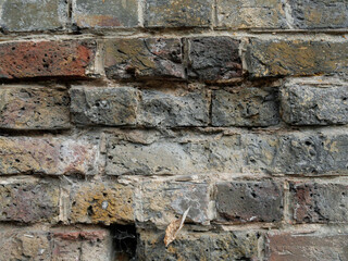 Old Brick wall weathered and damaged