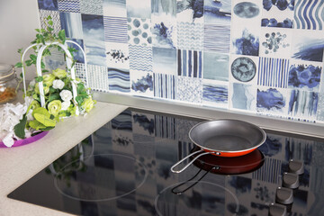 Electric stove. Frying pan is placed on a modern electric stove, black induction stove, cooker, hob...