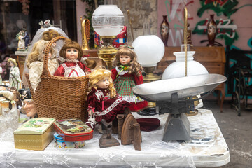 Haifa, Israel - September 02, 2022, Soviet-made baby doll in the style of the seventies in a knitted hat and dress on a table at a flea market.