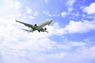 Fototapeta na wymiar Airplane flying high in blue sky. Modern aircraft