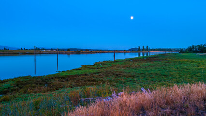 Moonrise night landscape over Swinomish Channel marshland near Skagit Bay in La Conner, Washington State