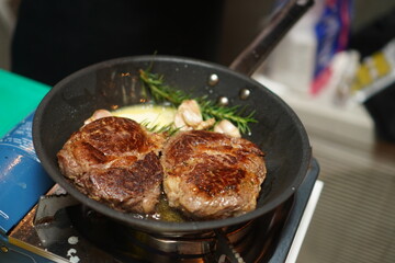 Cooking delicious beef steak in frying pan