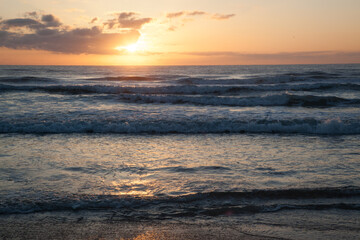 Sunrise over the ocean waves