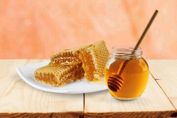 Tasty sweet honey and honey comb in wood background
