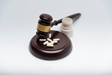 Medicine law concept. Gavel, stethoscope and pills isolated on white.