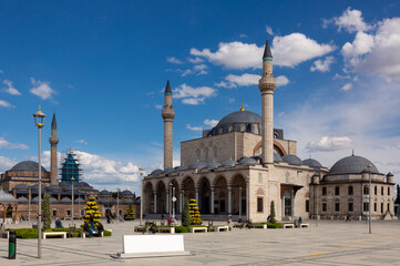 Fototapeta na wymiar Central square of Konya on sunny spring day overlooking medieval double-minaret Selimiye Mosque and small stele with name of city and inscription City of Hearts in English and Turkish, Turkey