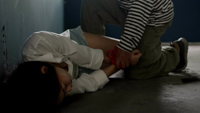Hostage woman modle was captured by the villain. Criminal and villain concept.