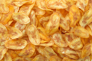 Pile banana slice chips texture background , top view , flat lay. © NUM LPPHOTO