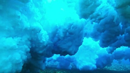 Powerful wave breaks underwater turbulence, wave crashing on the corral reef in tropical ocean. spinning vortex, clouds. powerful nature, strong wave, danger of drowning. slow motion.