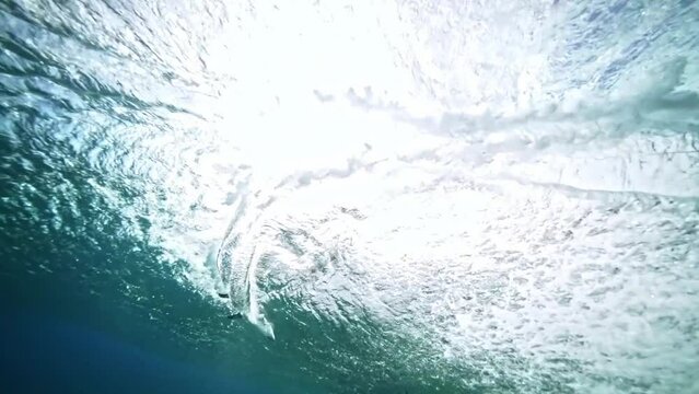 Underwater Tahiti. Glassy ocean tube wave crashing, perfect barrel for surfing. Teahupoo famous surfing action sports destination in French Polynesia. slow motion. 