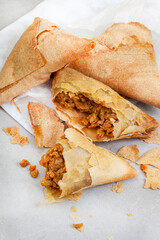South African chicken Samosas on mottled grey with copy space