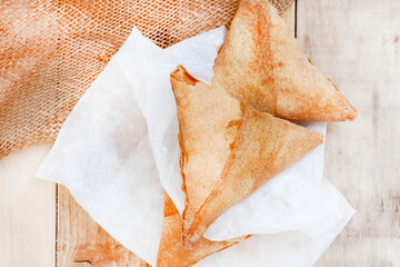 South African chicken Samosas on rustic table