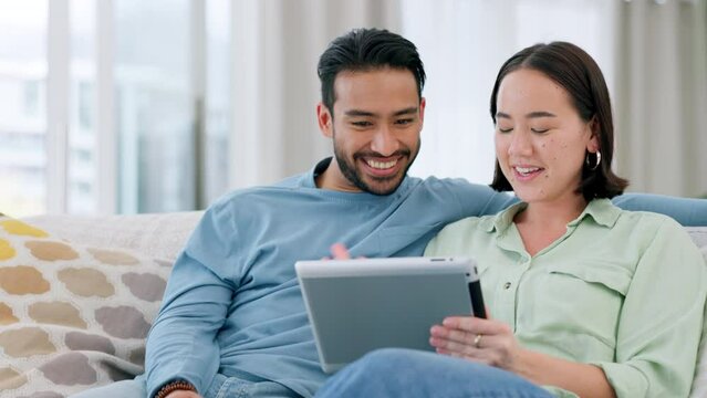 Couple streaming funny meme video on tablet online, watching comedy movie on technology and relax with internet connection for social media. Comic, talking and Asian man and woman on web on the sofa