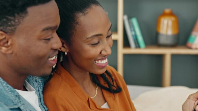 Happy, love and couple on a phone streaming a online subscription service entertainment movie, tv series or video. Married black woman and man relax in home living room sofa on social media together