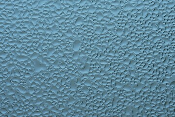 water droplet macro photo on the glass window in the morning