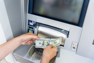 Atm card machine cash. Holding american bill cash. Woman withdraw money usd hundred dollar. Bank...