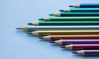 Obraz premium Colored pencils with a metallic sheen close-up. Background with place for text. High quality photo