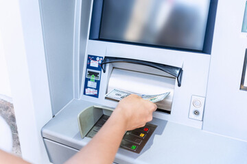 Atm card machine cash. Holding american bill cash. Woman withdraw money usd hundred dollar. Bank...