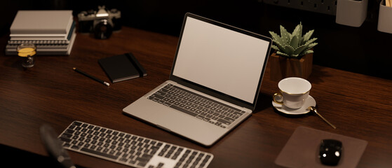 Modern stylish vintage wood workspace with laptop mockup and accessories on dark wood tabletop.