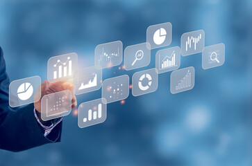 Big data analytics BI intelligence business concept with chart and graph icons on virtual screen interface and a businessman in background.
