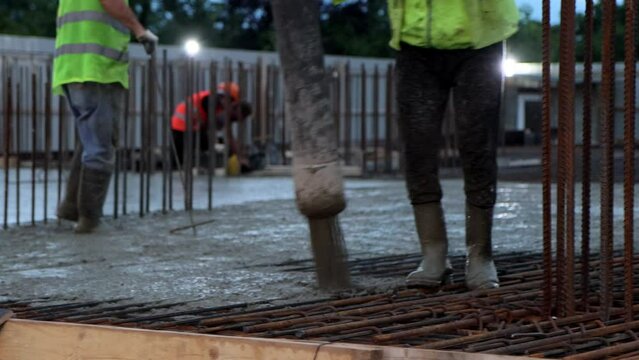 Men are pouring foundation with pump construction site. Concrete pours from pump concept, 4k.