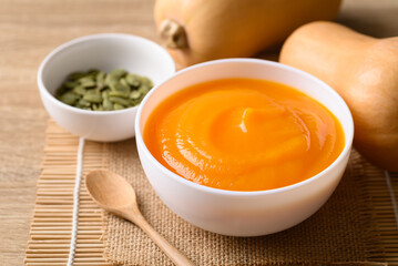 Butternut squash pumpkin soup in bowl, Homemade food in autumn season