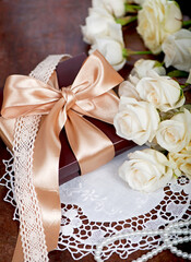 empty card form and bouquet of white rose with green leaves on a wooden