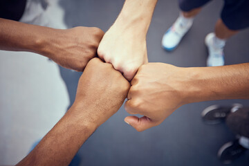 Teamwork, hands and collaboration with people standing in a circle or huddle in support, unity or solidarity. Team, group of community with fists joined in union together from above and closeup