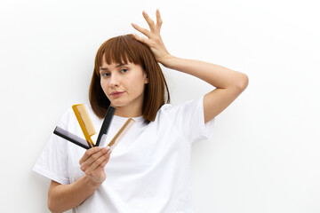 a beautiful, pleasant woman with a beautiful hairstyle holds her hand above her head in a funny...