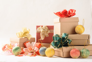 Christmas gift box and ball ornament on white paper background
