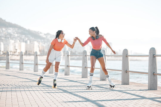 Black women, fist bump and roller skating happy friends by the sea, ocean or shore outdoors. Support, partnership and girl team collaboration or fun while traveling down promenade together.