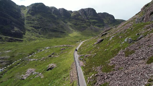 Aerial view of a car driving on the mountain pass in Applecross, Scotland, United Kingdom.