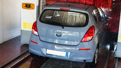 Automatic car wash. Auto brush washer clean blue car on automatic carwash station. Automatic car...