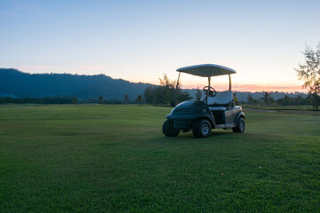 Golf cart in golf course sunset time