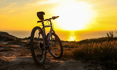 silhouette of  a bicycle in sunrise