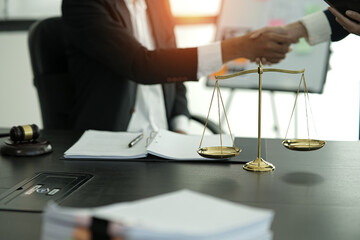 judge on wooden table And experienced lawyers meet with clients and give advice behind the scenes....