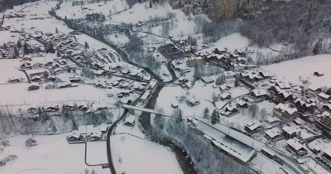 Panorama aerial Drone shot of Cottages chalets in Lauterbrunnen village at snowy winter. Traditional Walser mountain village in the canton of Bern in Switzerland. Popular tourist spots in Interlaken.