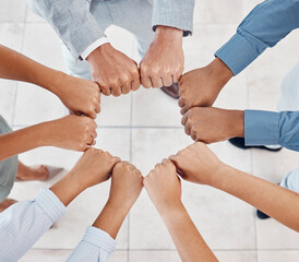 Fist of diversity business team work together in partnership, collaboration and teamwork top view....