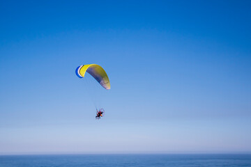 Paraglider flight over the sea